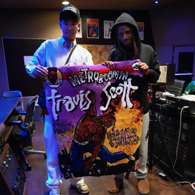 Zudy and Metro Boomin holding a custom tufted rug in the studio